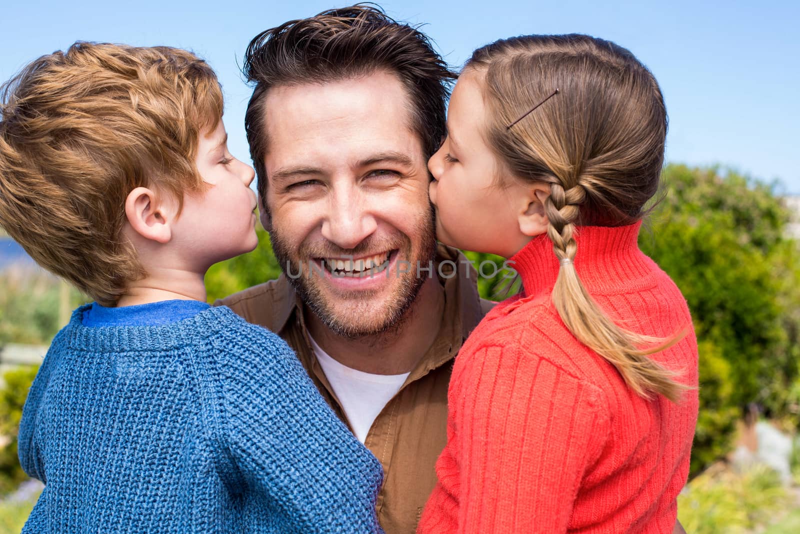 Happy father smiling at camera in the countryside