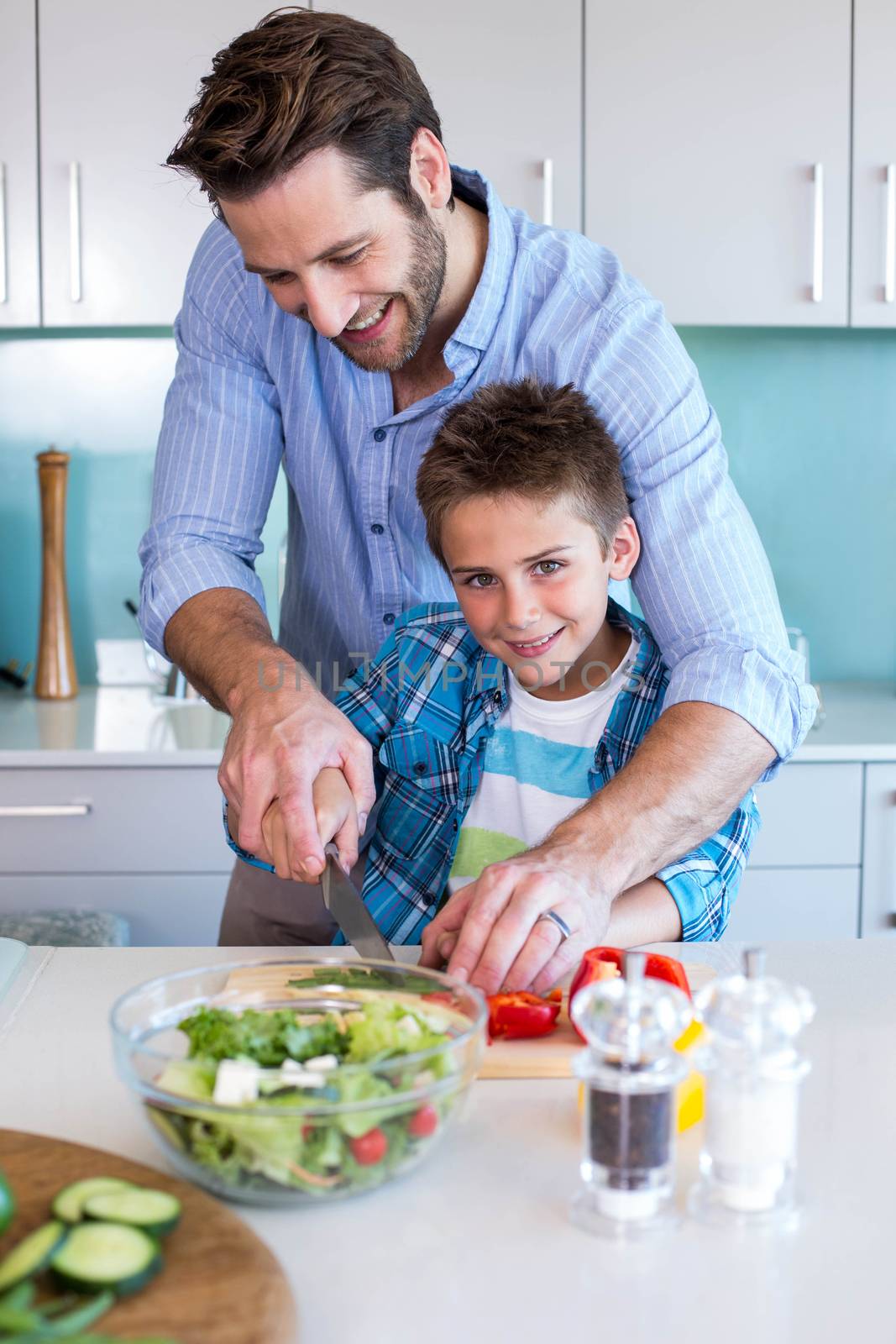 Happy family preparing vegetables together by Wavebreakmedia