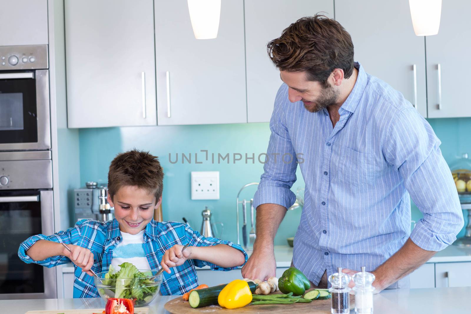 Happy family preparing lunch together at home in the kitchen