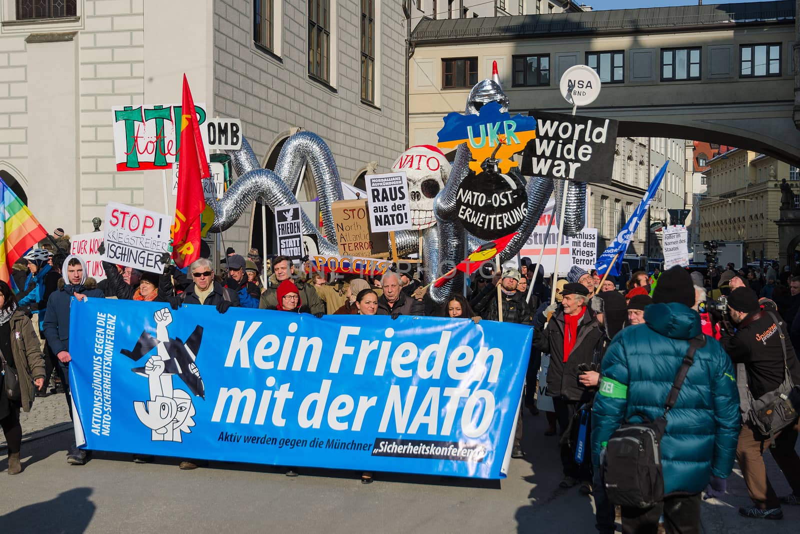 Munich, Germany - February 7, 2015: European anti-NATO peaceful protest demonstration. Texts on banners and placards says: "Stop North Atlantic Alliance eastward expansion", "No friendship with NATO".