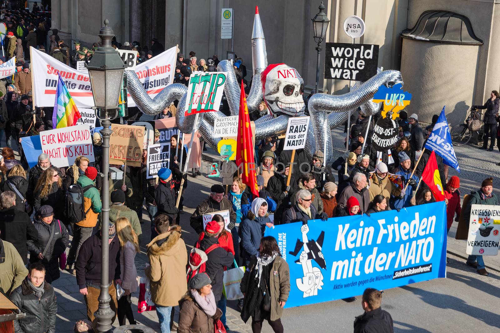 Munich, Germany - February 7, 2015: NATO in Europe like an octopus. Peaceful demonstration anti-NATO pacific protest rally. Text on the banner reads as "No friendship with NATO"