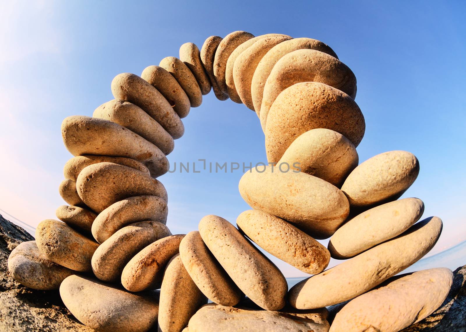 Arch of pebbles between of the stones on the seashore
