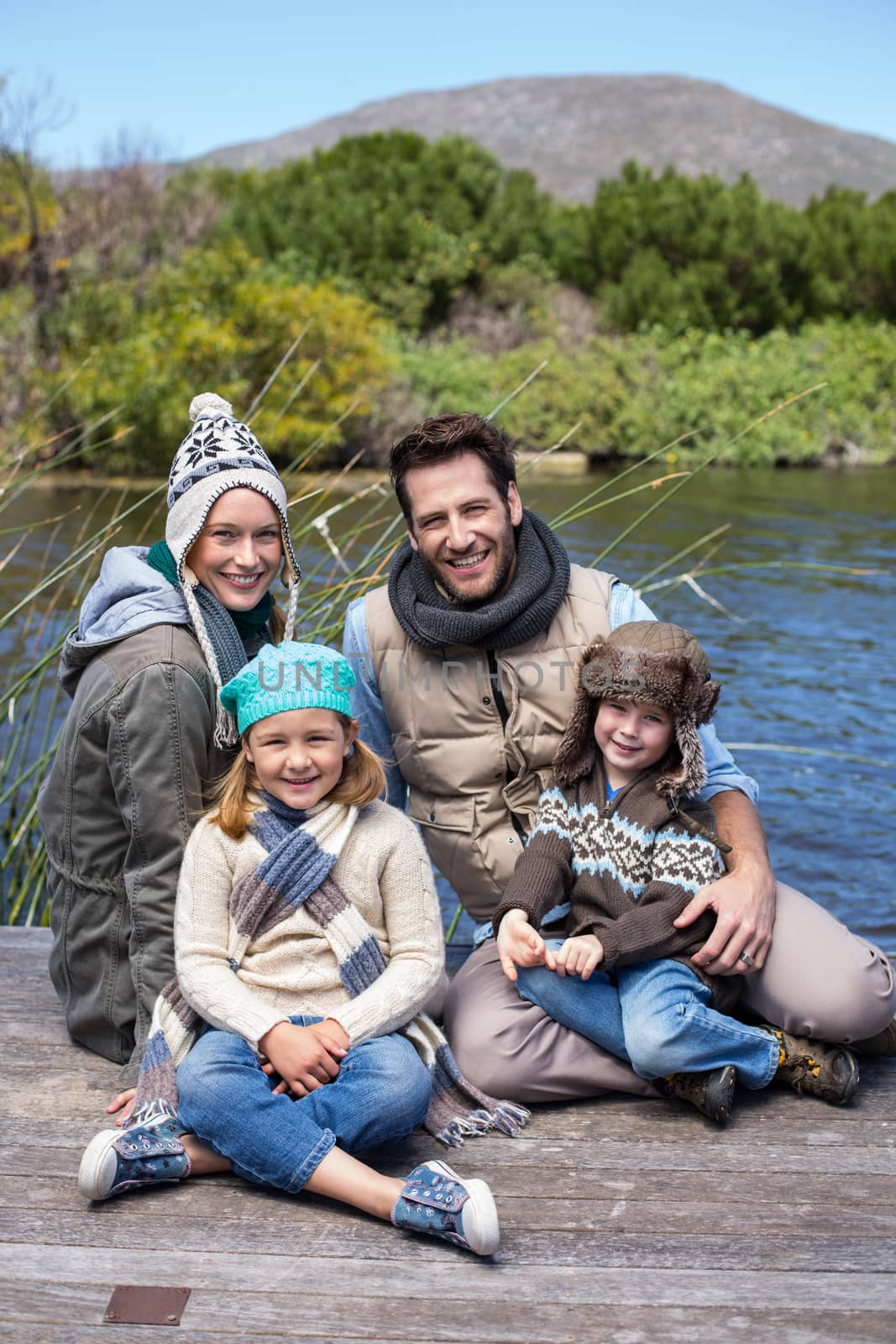 Happy casual family at a lake in the countryside