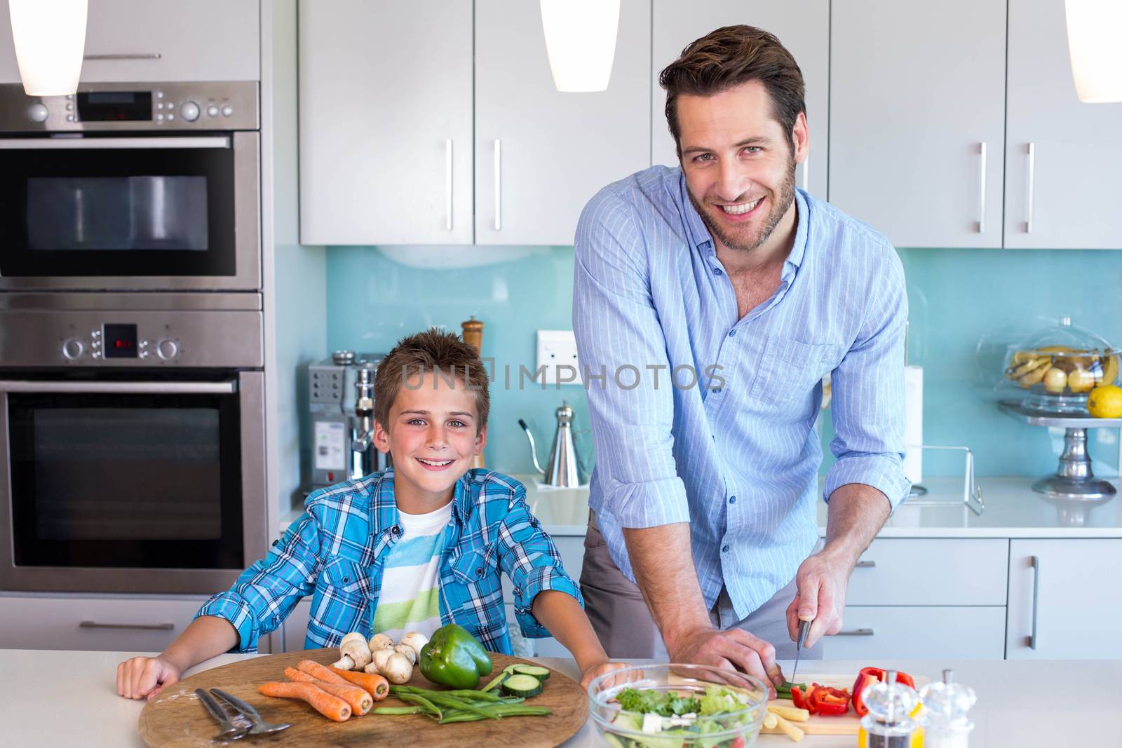 Happy family preparing lunch together by Wavebreakmedia