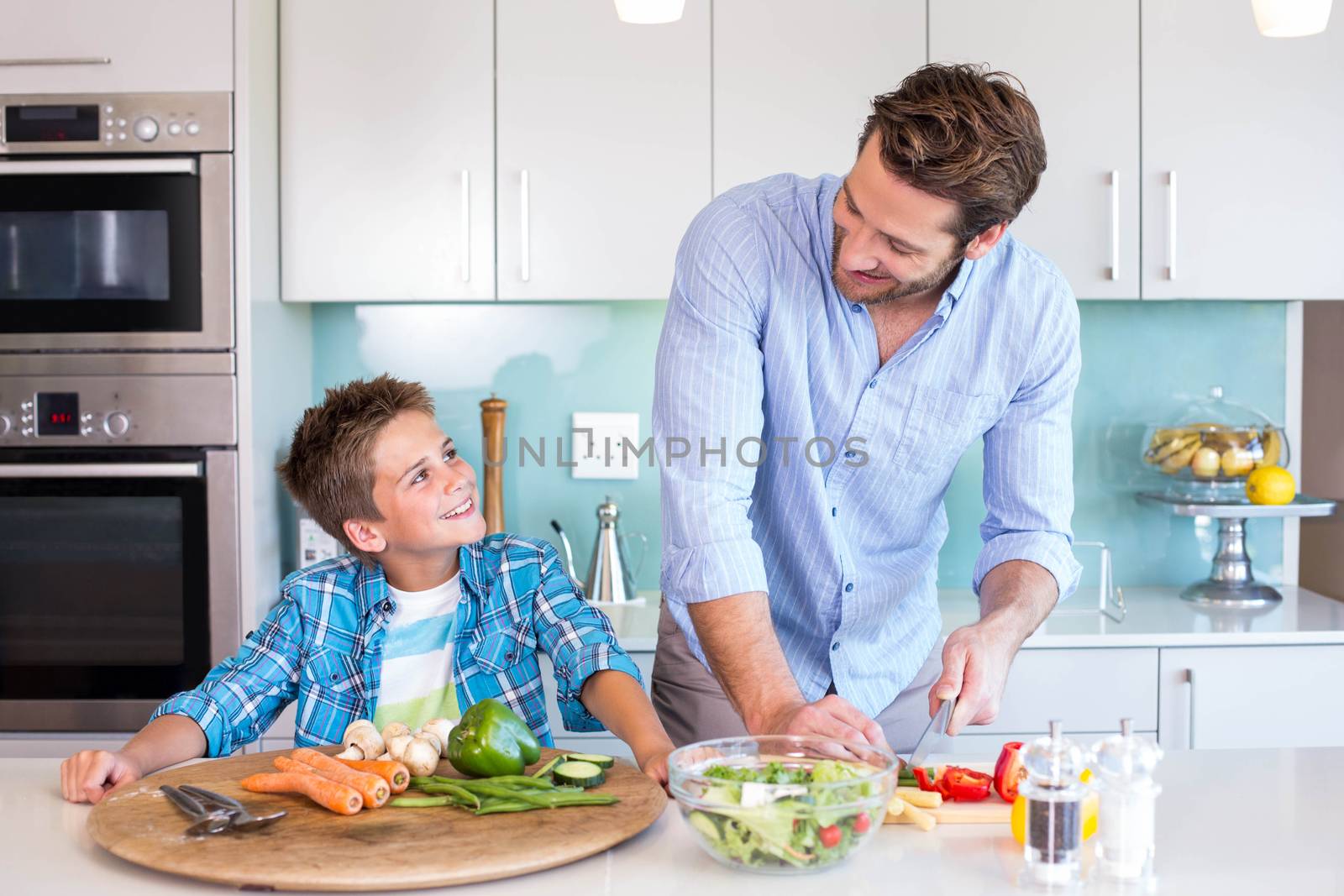 Happy family preparing lunch together at home in the kitchen