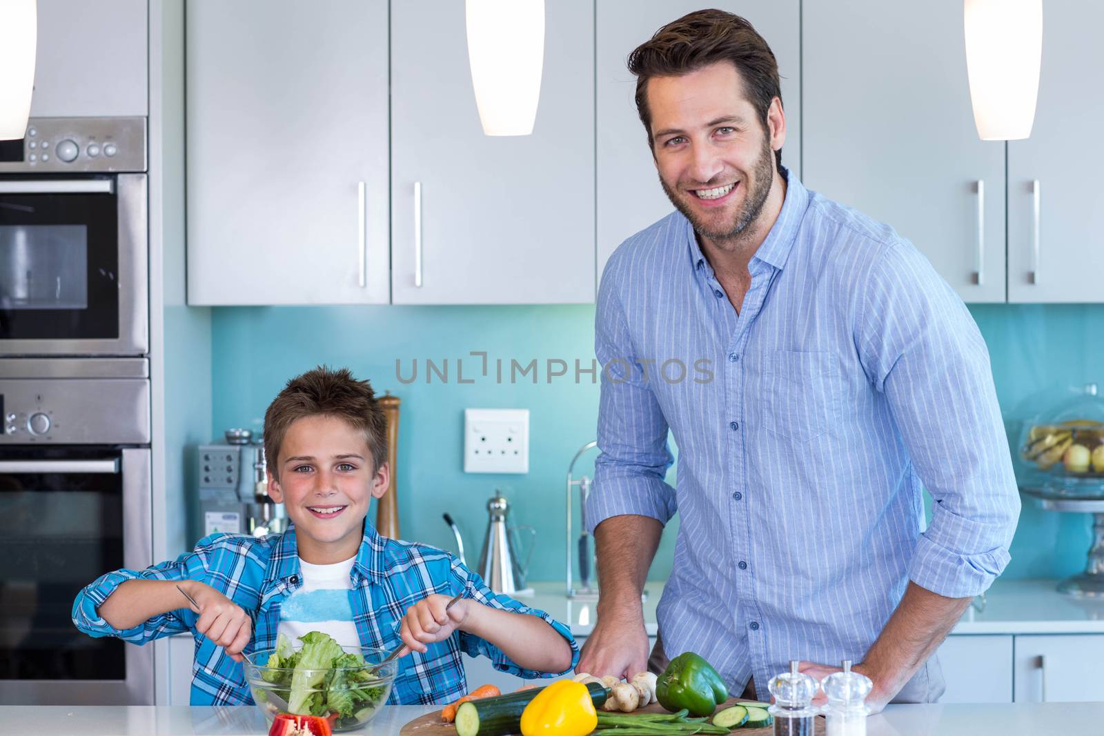 Happy family preparing lunch together at home in the kitchen