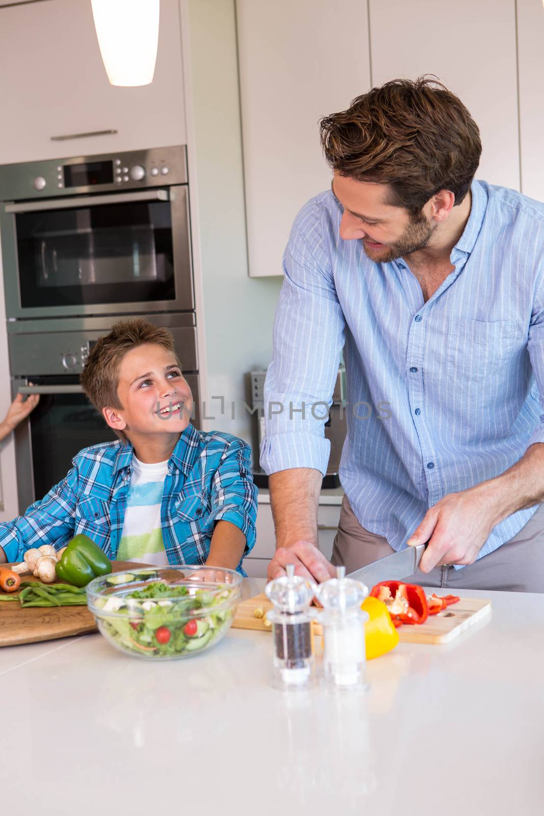 Happy family preparing vegetables together by Wavebreakmedia