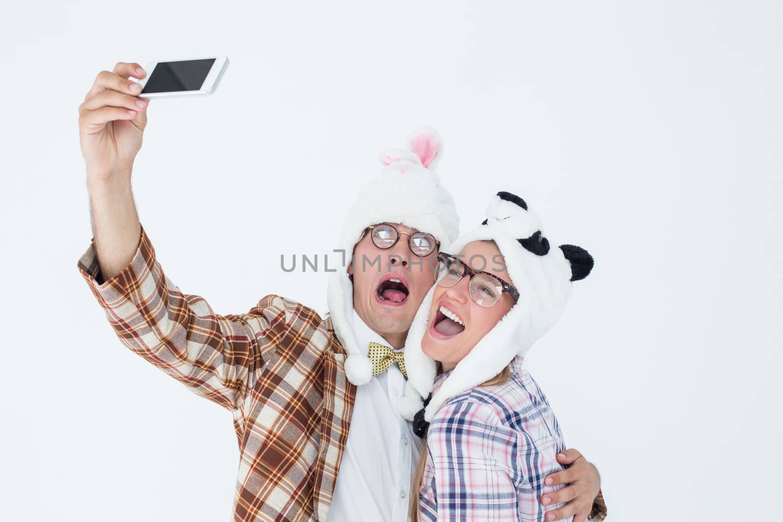 Geeky hipster couple taking selfie with smart phone  by Wavebreakmedia