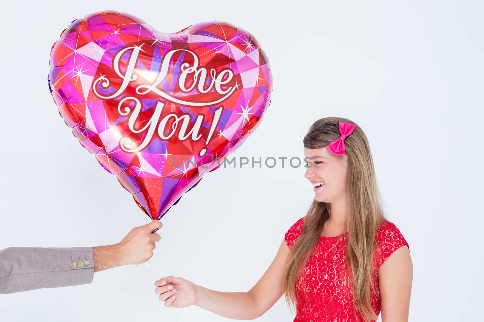 Geeky hipster offering red heart shape balloon to his girlfriend on white background 