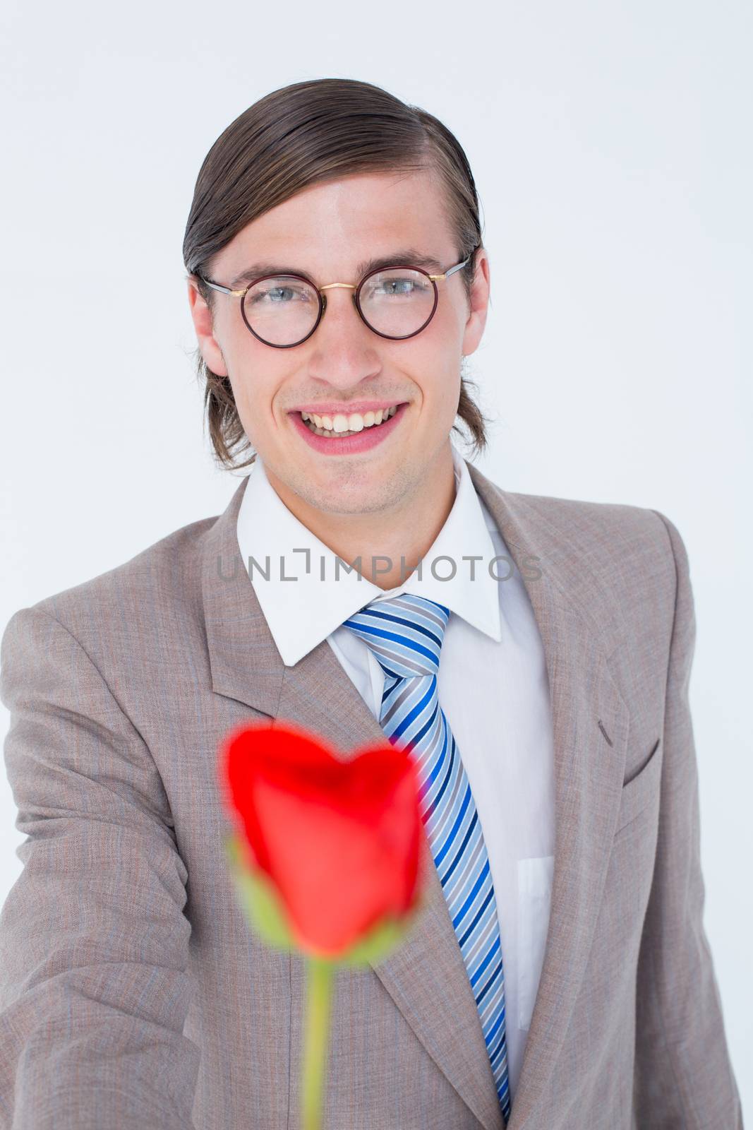 Geeky businessman offering a rose on white background