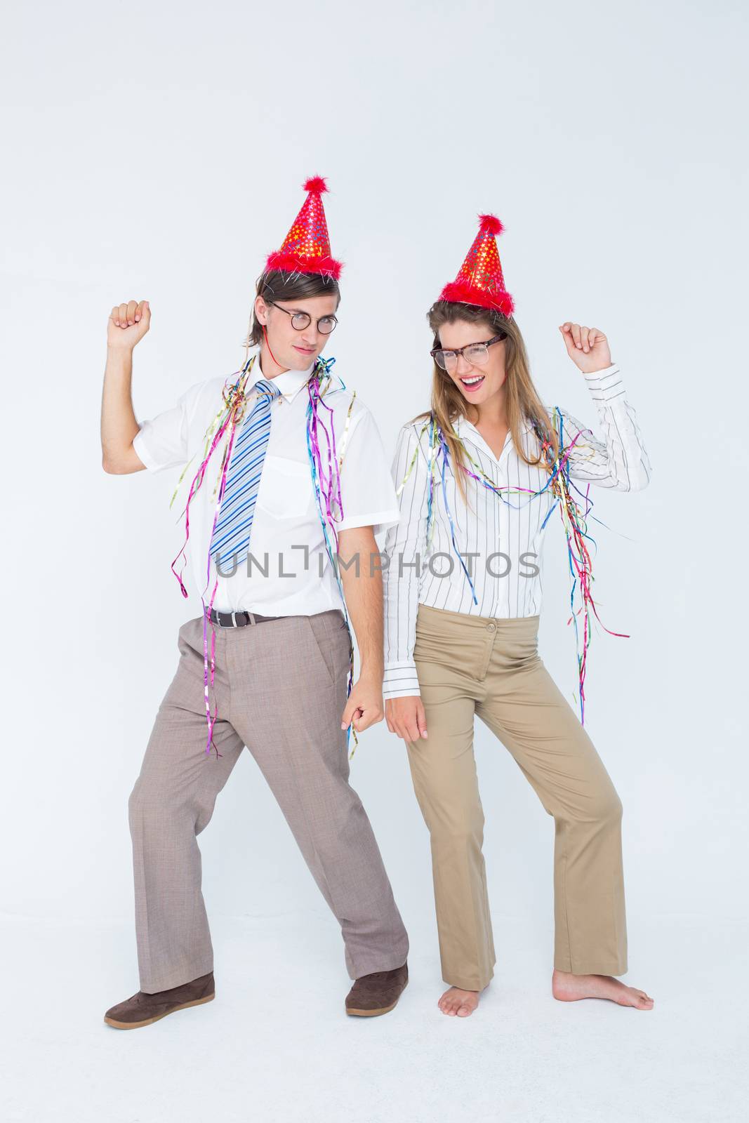 Happy geeky couple dancing on white background