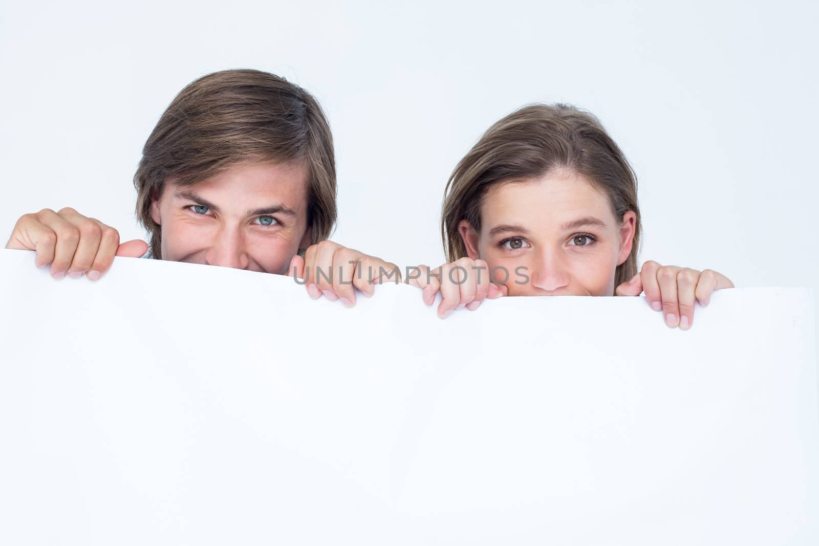 Hipster couple holding poster on white background