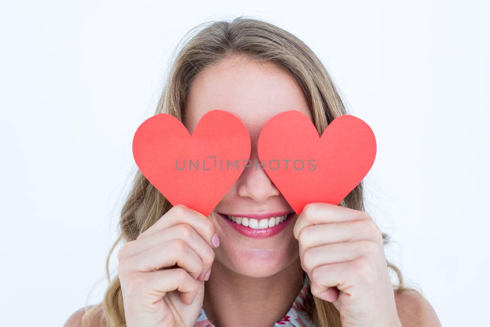 Woman holding heart cards  by Wavebreakmedia