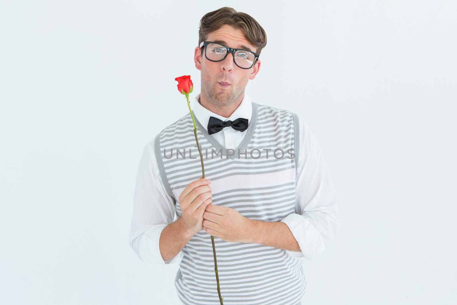 Geeky hipster holding a red rose  by Wavebreakmedia
