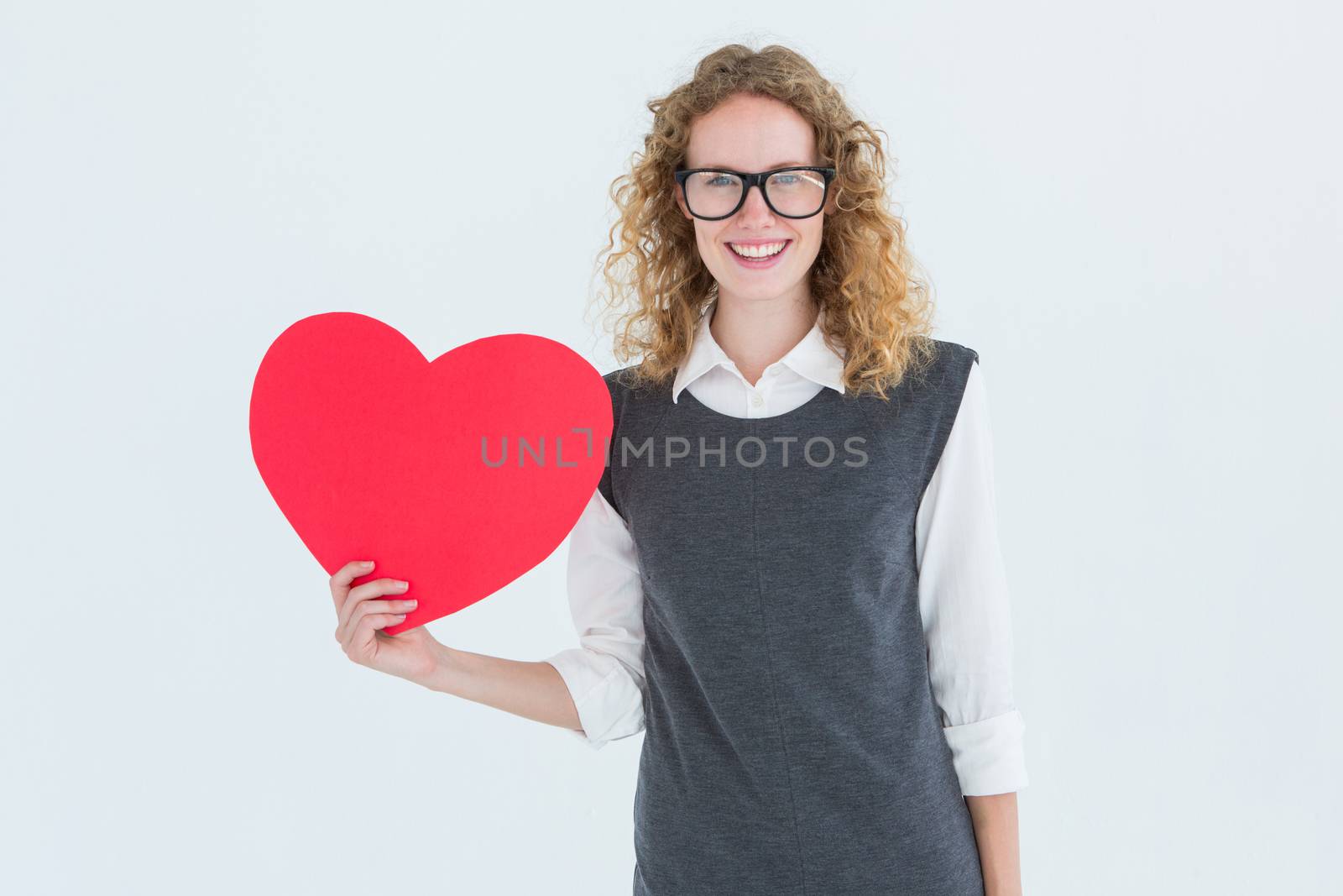 Geeky hipster holding heart card on white background