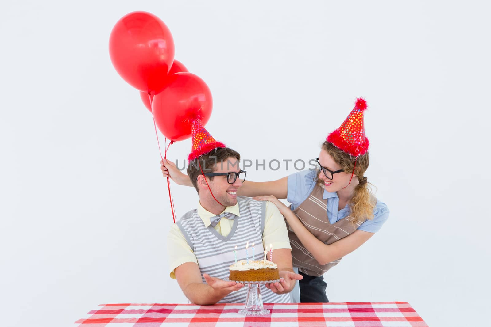 Geeky hipster couple celebrating his birthday  by Wavebreakmedia