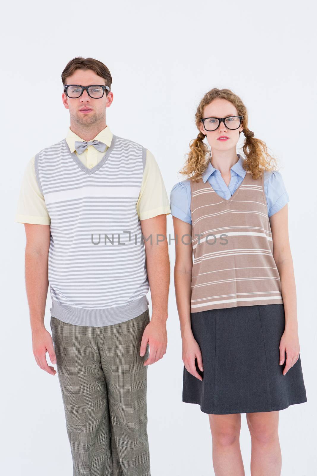 Geeky hipster couple looking at camera  by Wavebreakmedia