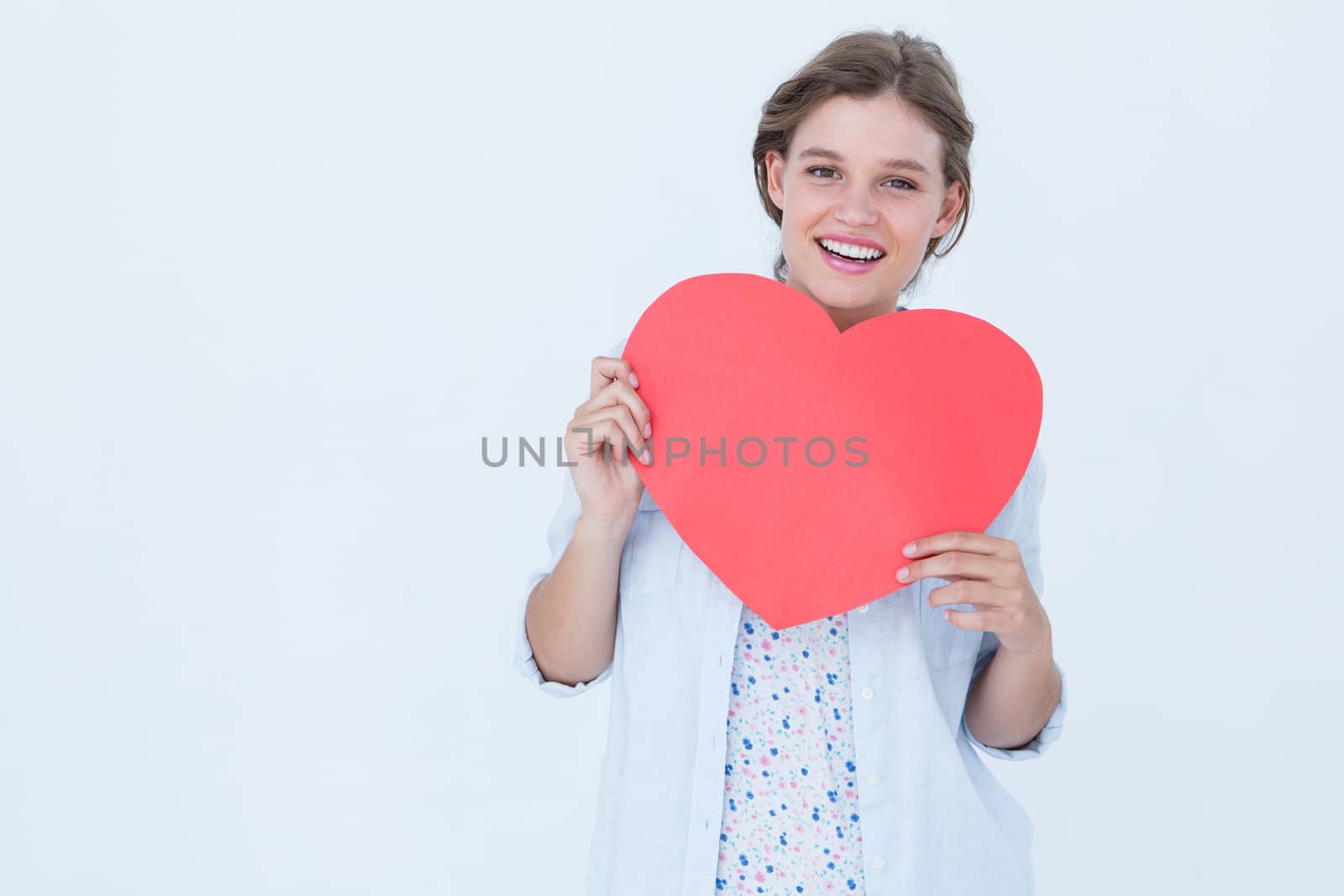 Woman holding heart card on white background 