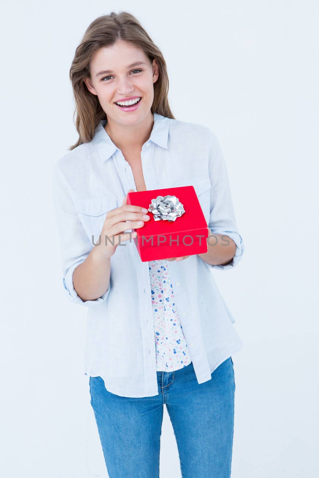 Happy woman opening a present on white background