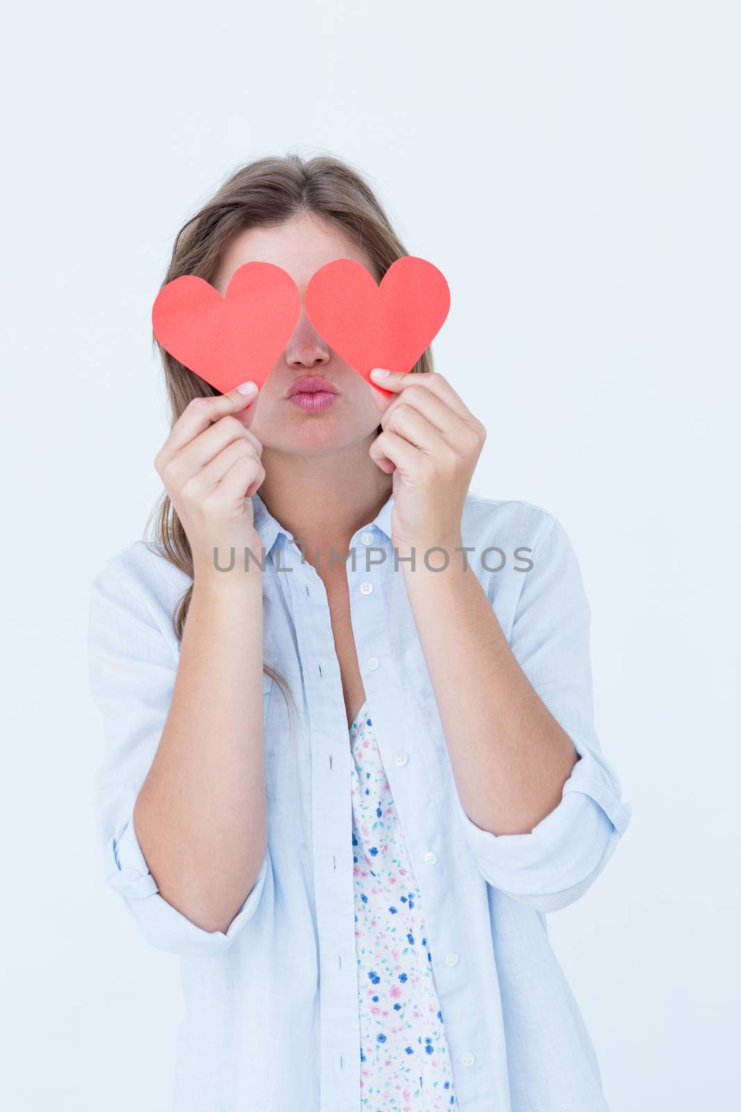 Woman holding heart cards on white background