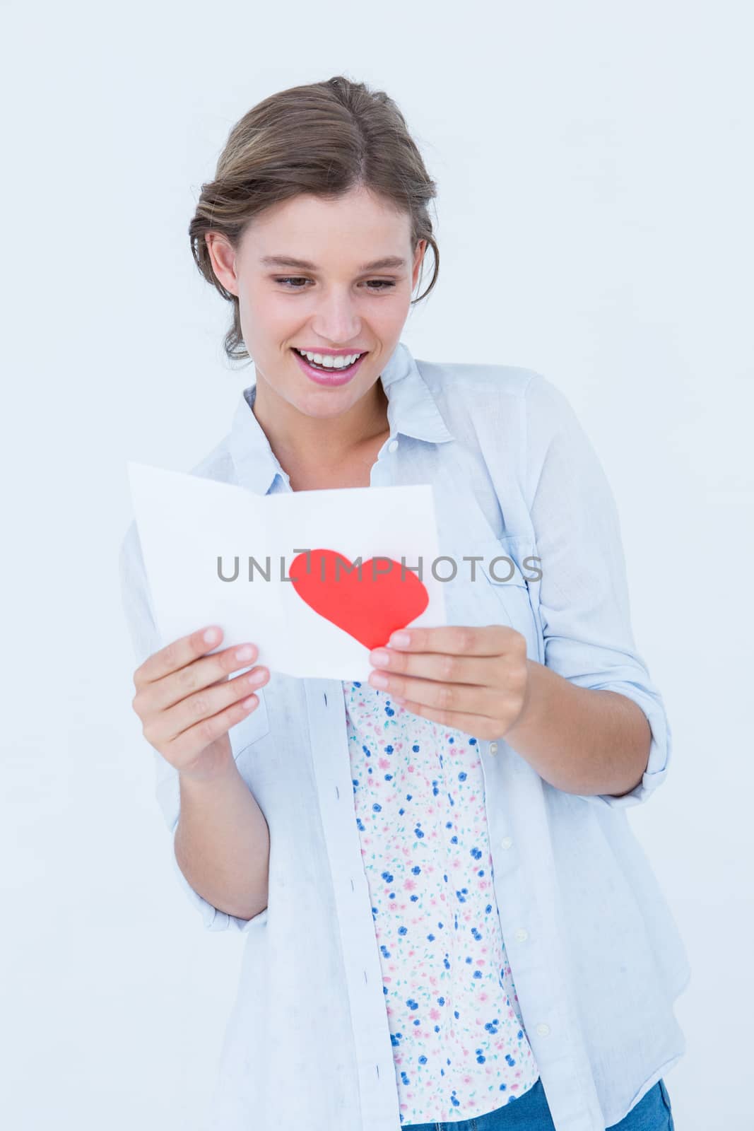 Smiling woman reading love letter on white background