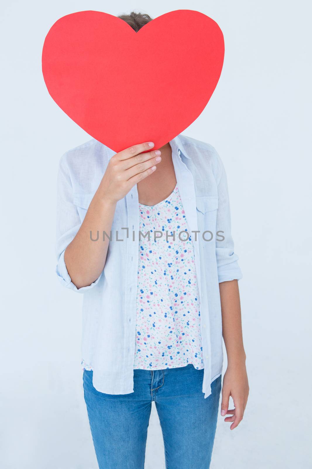 Woman holding heart card on white background