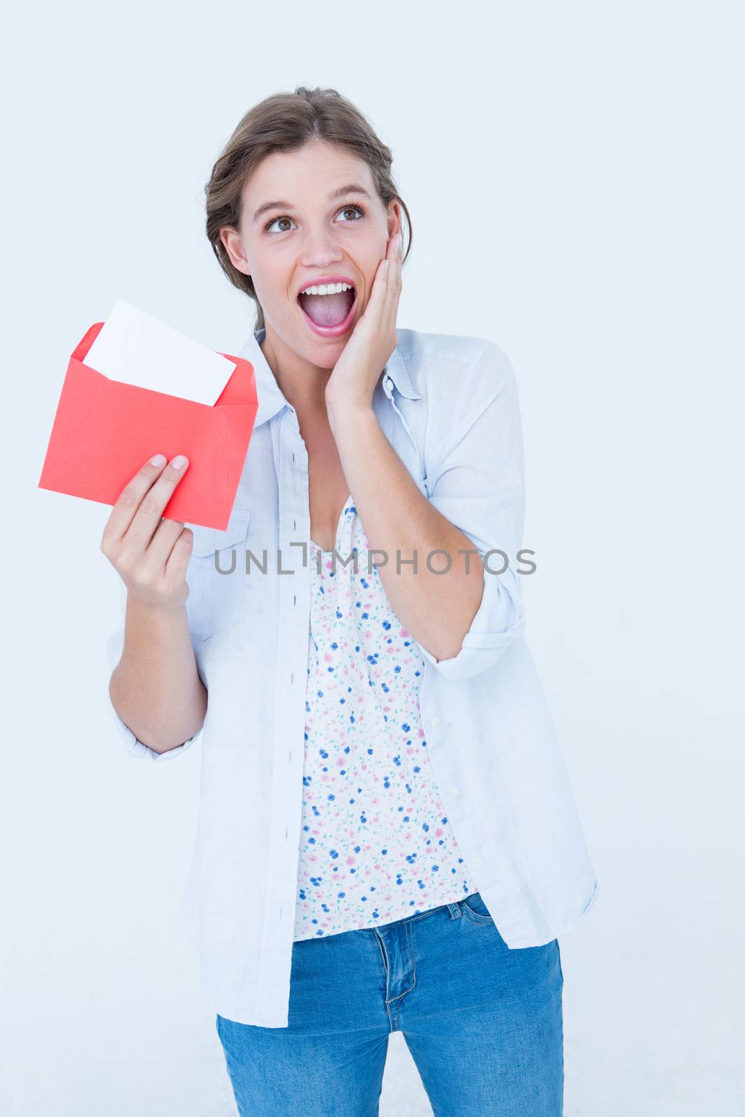Smiling woman reading letter  by Wavebreakmedia