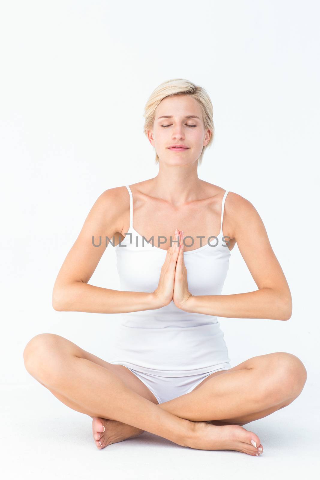 Fit woman doing yoga on white background