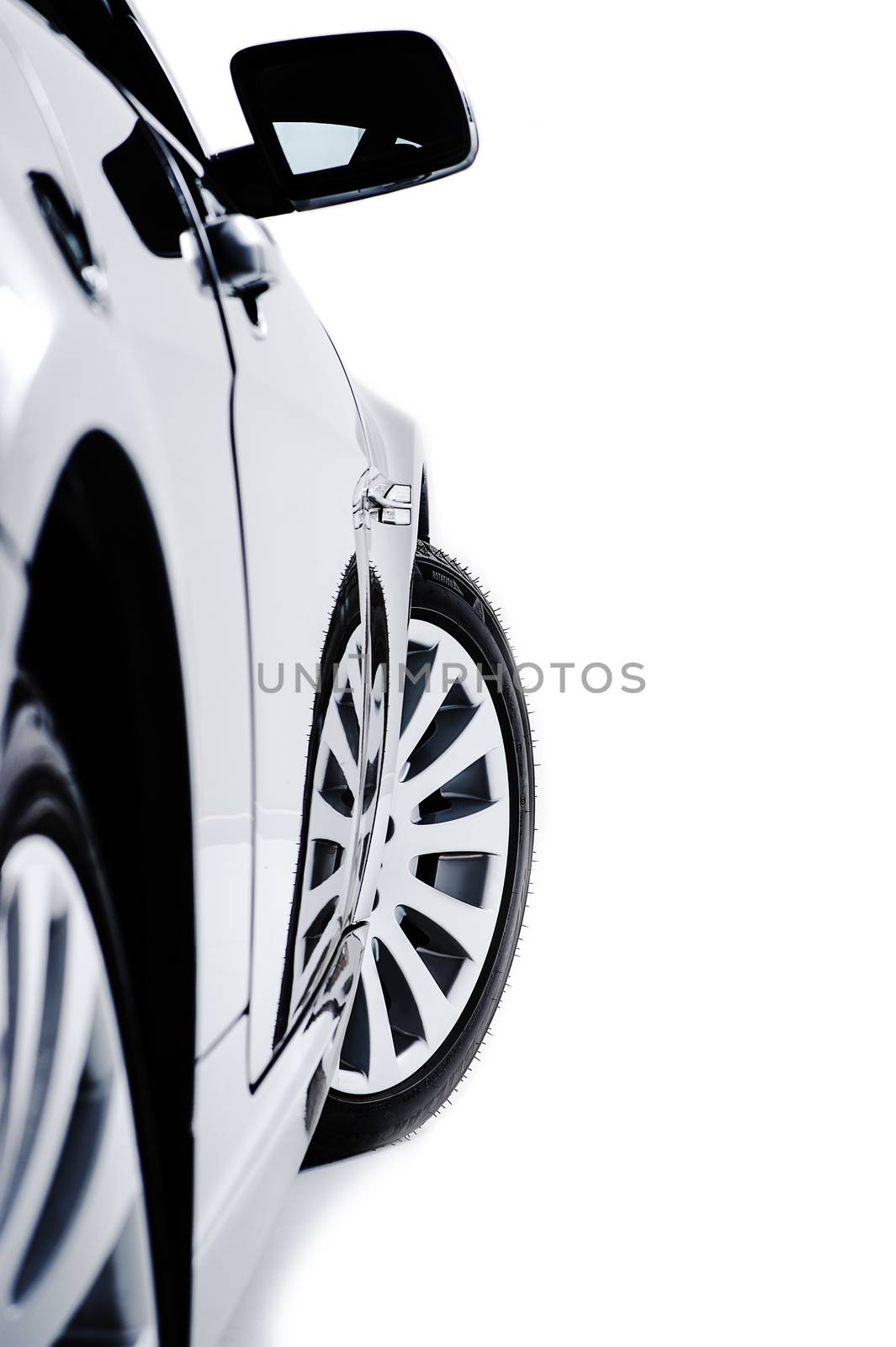 Side of a modern car with alloy sport wheels by MOELLERTHOMSEN