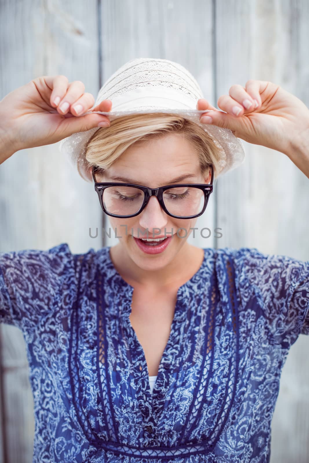 Pretty blonde woman wearing hipster glasses on wooden background