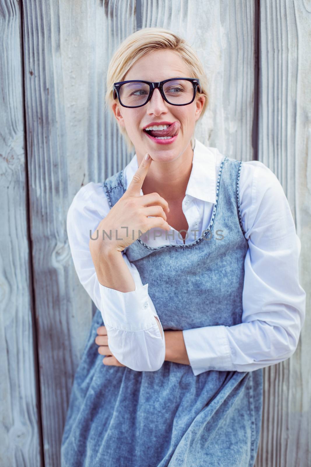 Pretty blonde woman having fun on wooden background