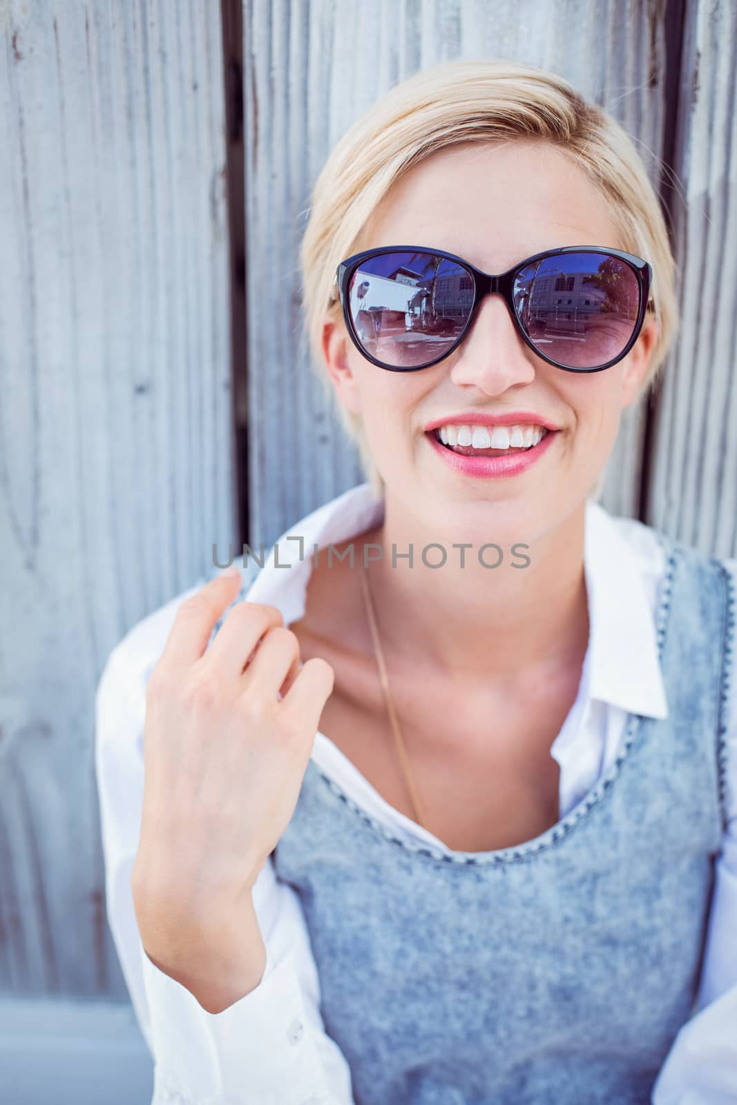 Pretty blonde woman wearing sun glasses by Wavebreakmedia