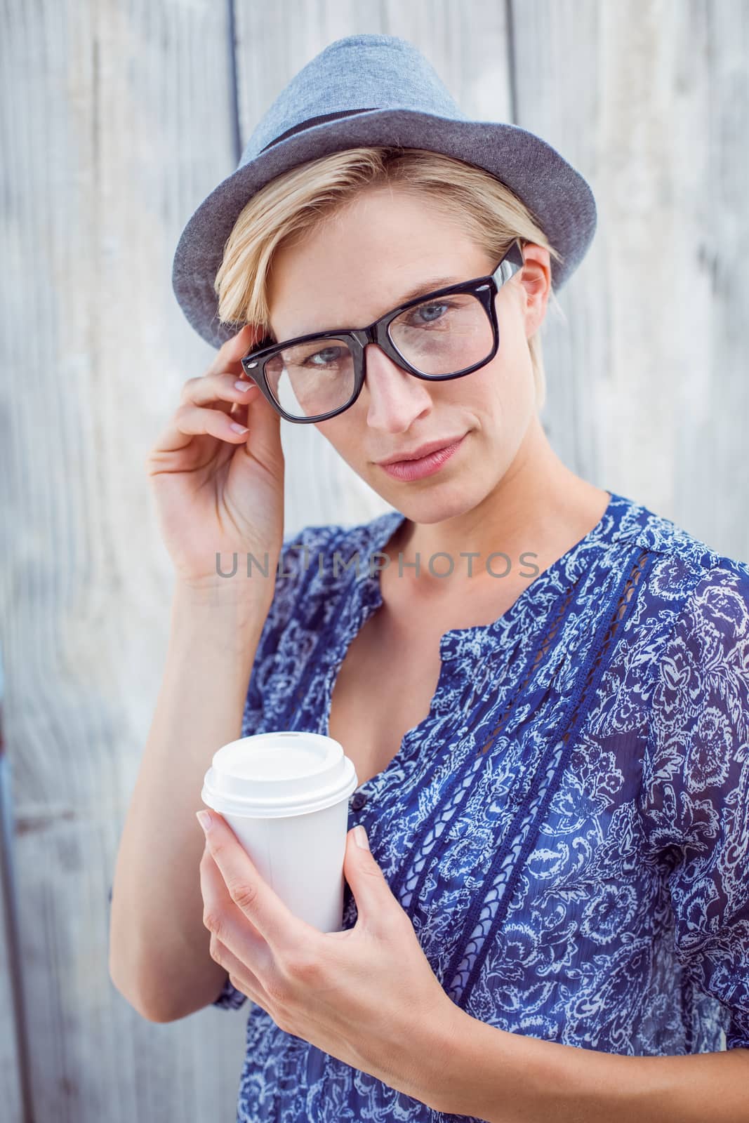 Pretty blonde woman holding goblet by Wavebreakmedia