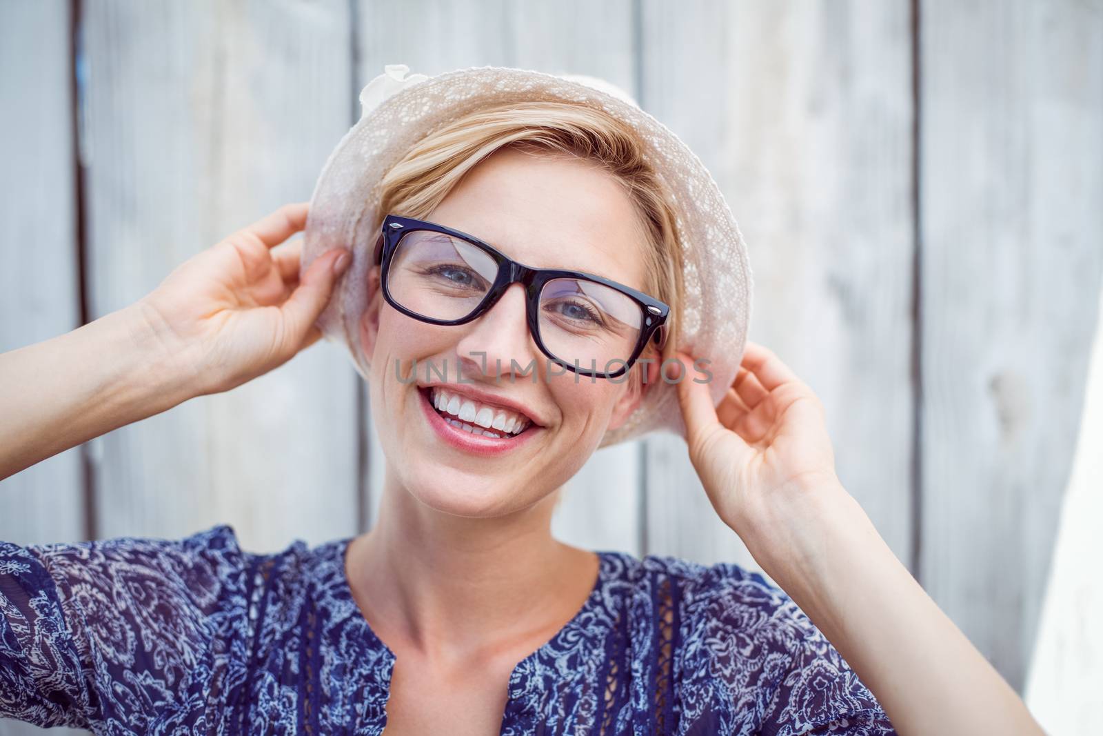 Pretty blonde woman wearing hipster glasses by Wavebreakmedia