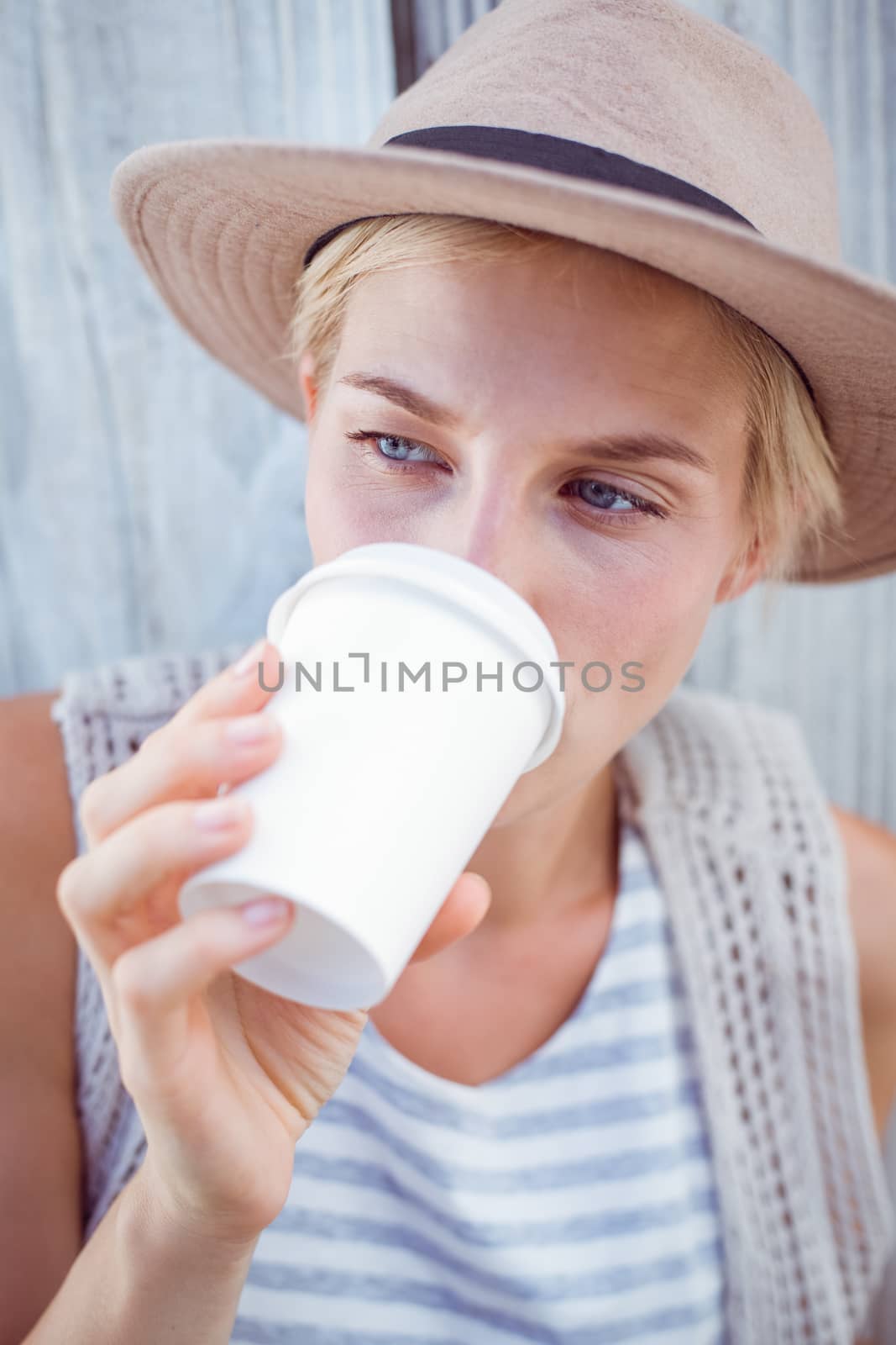 Pretty blonde woman drinking coffee by Wavebreakmedia
