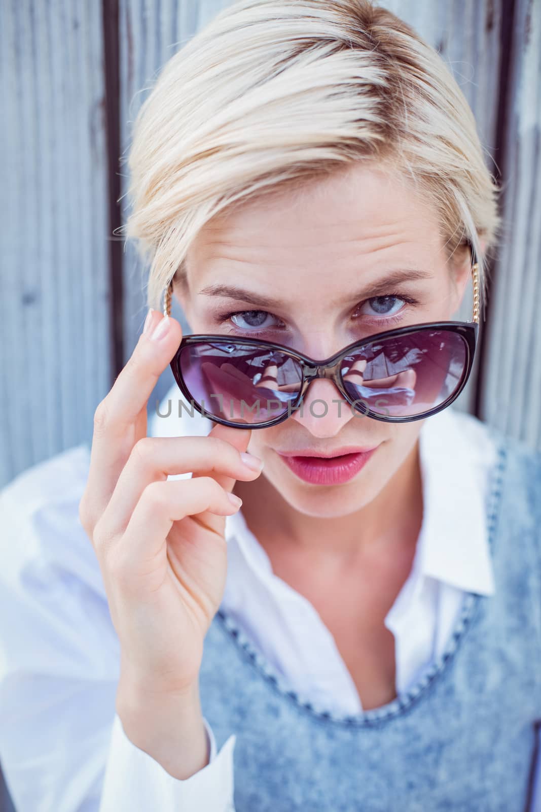 Pretty blonde woman wearing sun glasses by Wavebreakmedia