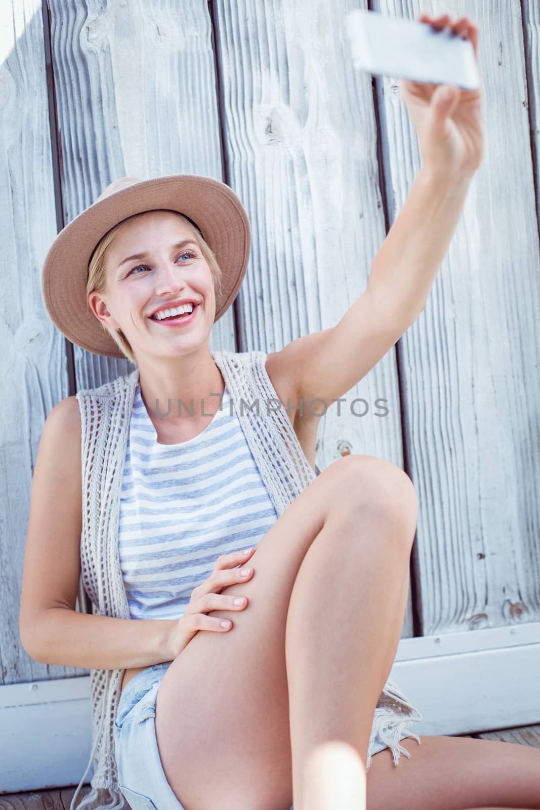 Pretty blonde woman taking selfie by Wavebreakmedia