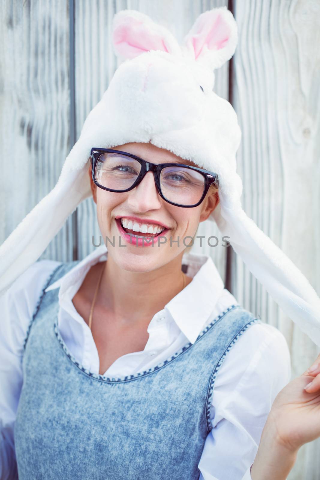 Pretty blonde woman smiling at the camera wearing funny hat by Wavebreakmedia