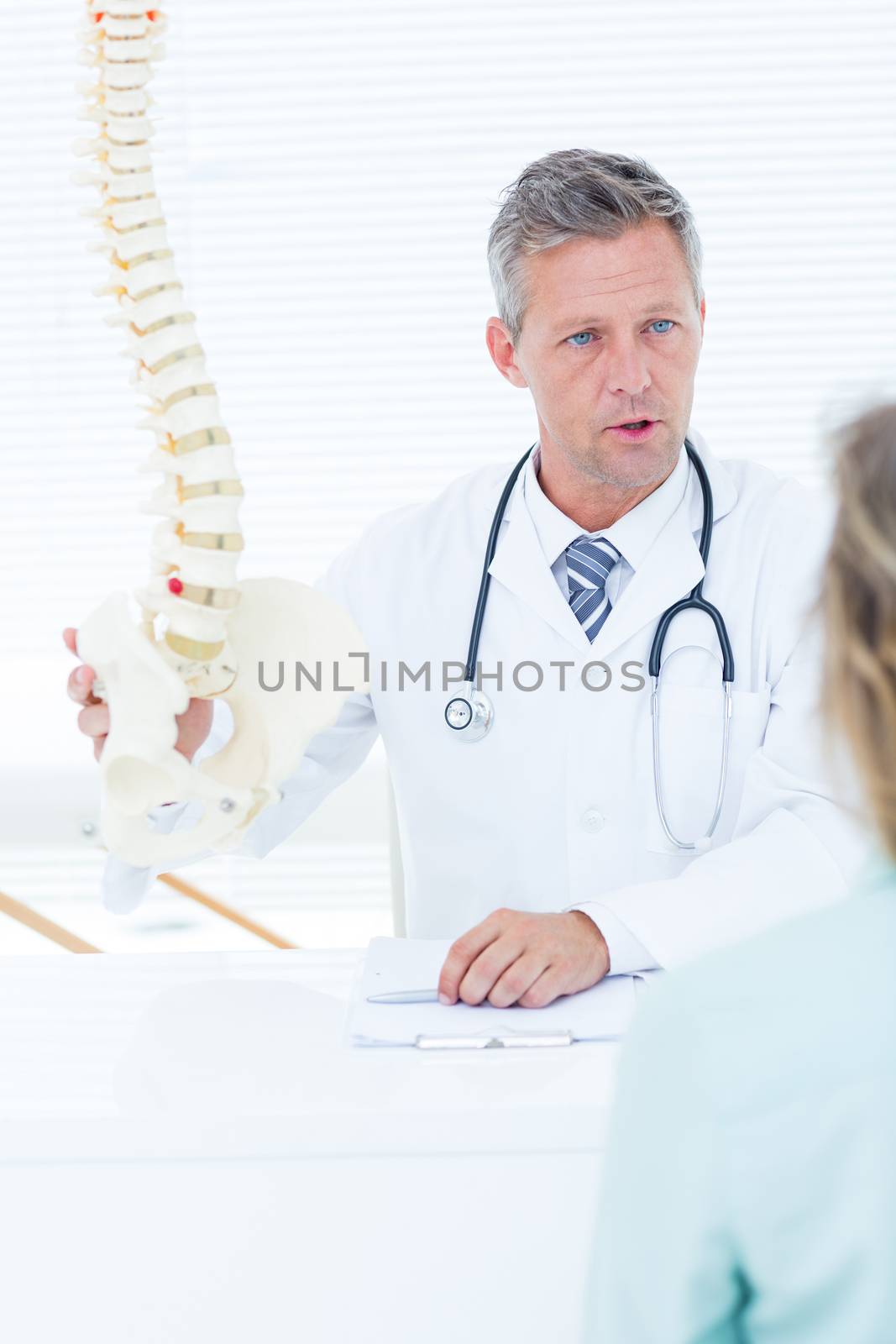 Doctor having conversation with his patient in medical office