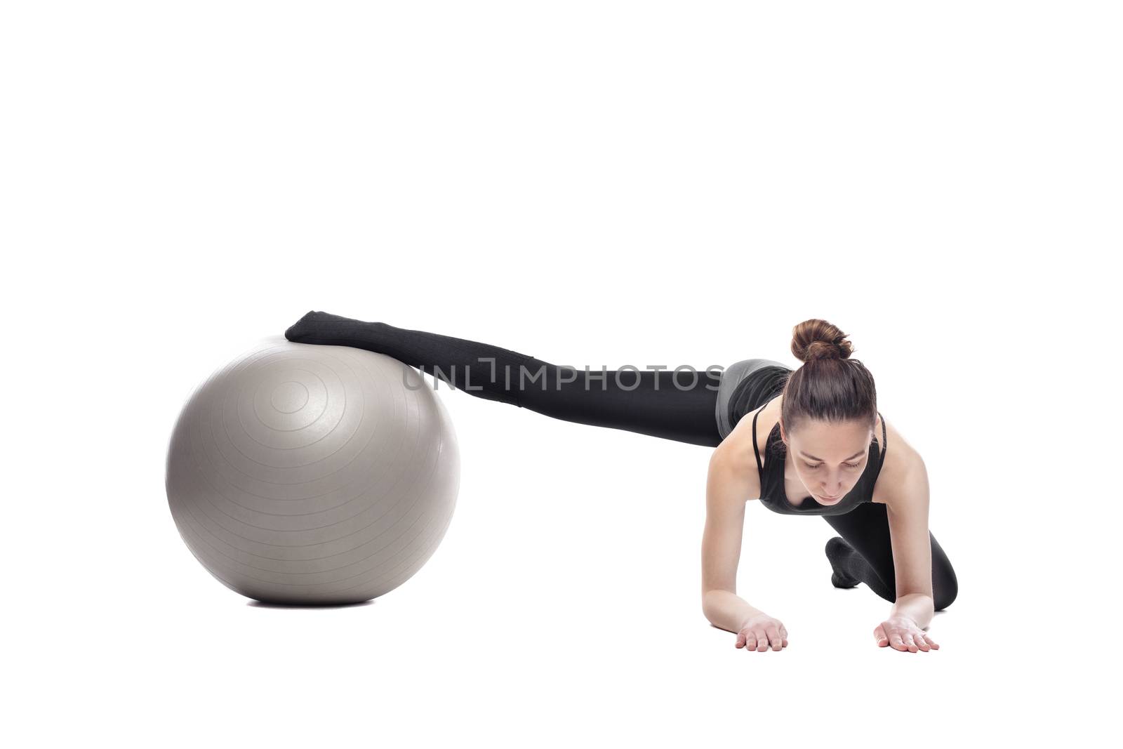 Caucasian woman exercising pilates poses, isolated in studio