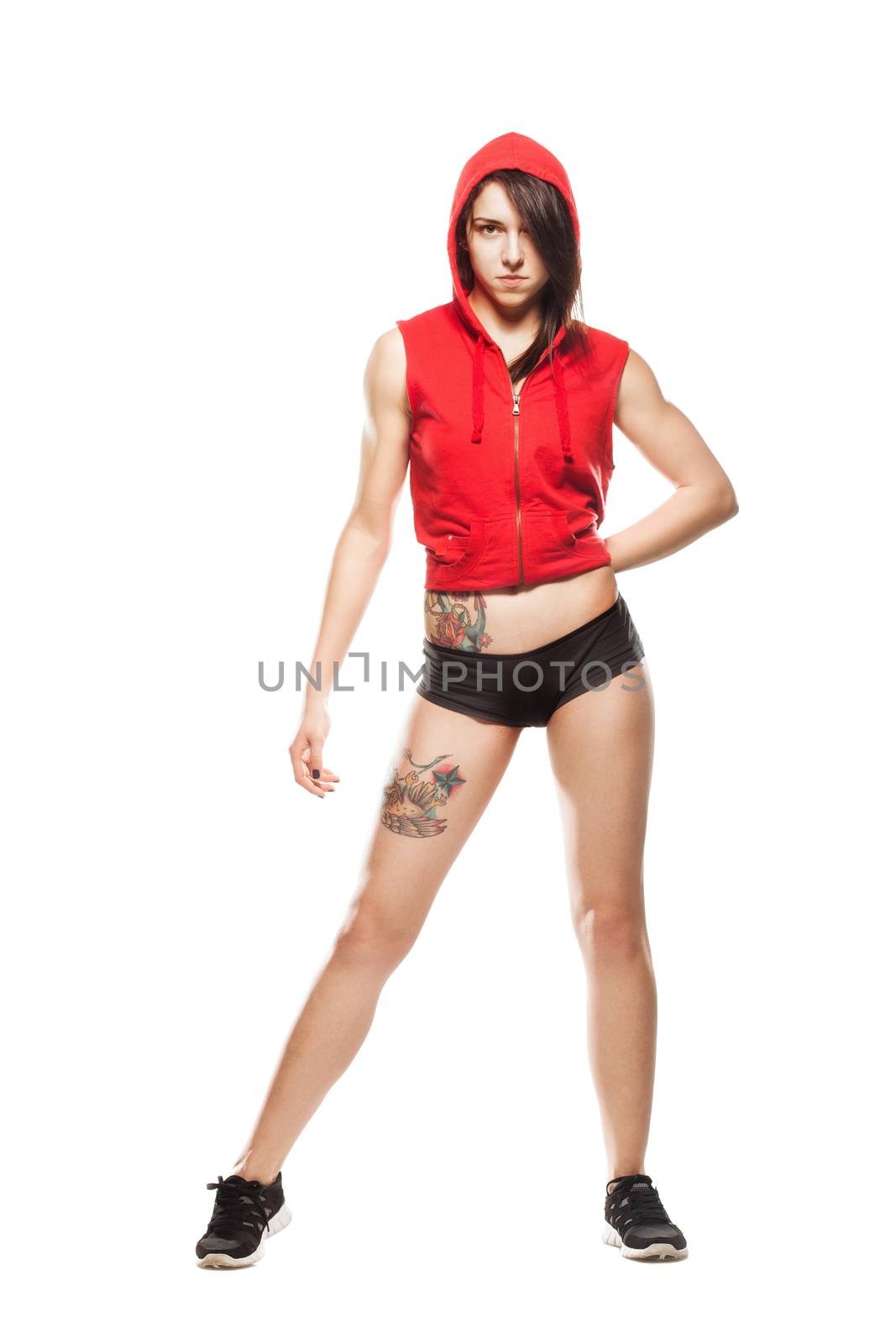 Fitness girl. Sexy athletic woman posing in red hoodie