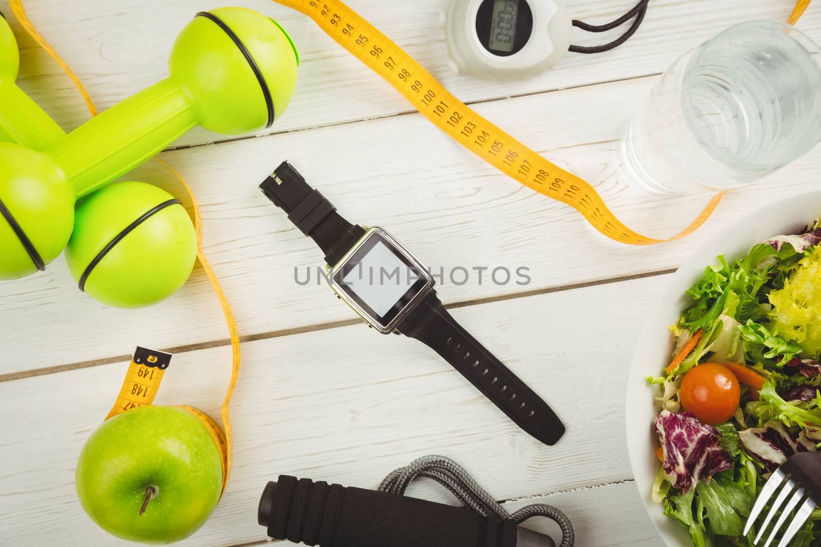Watch with indicators of healthy lifestyle on wooden table