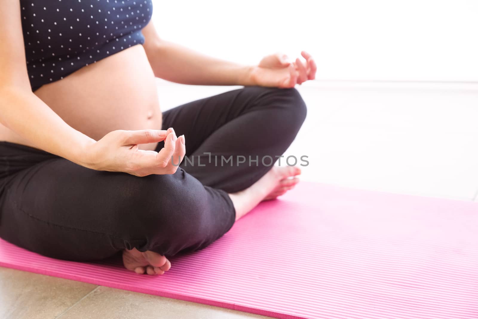 Pregnant woman keeping in shape by Wavebreakmedia