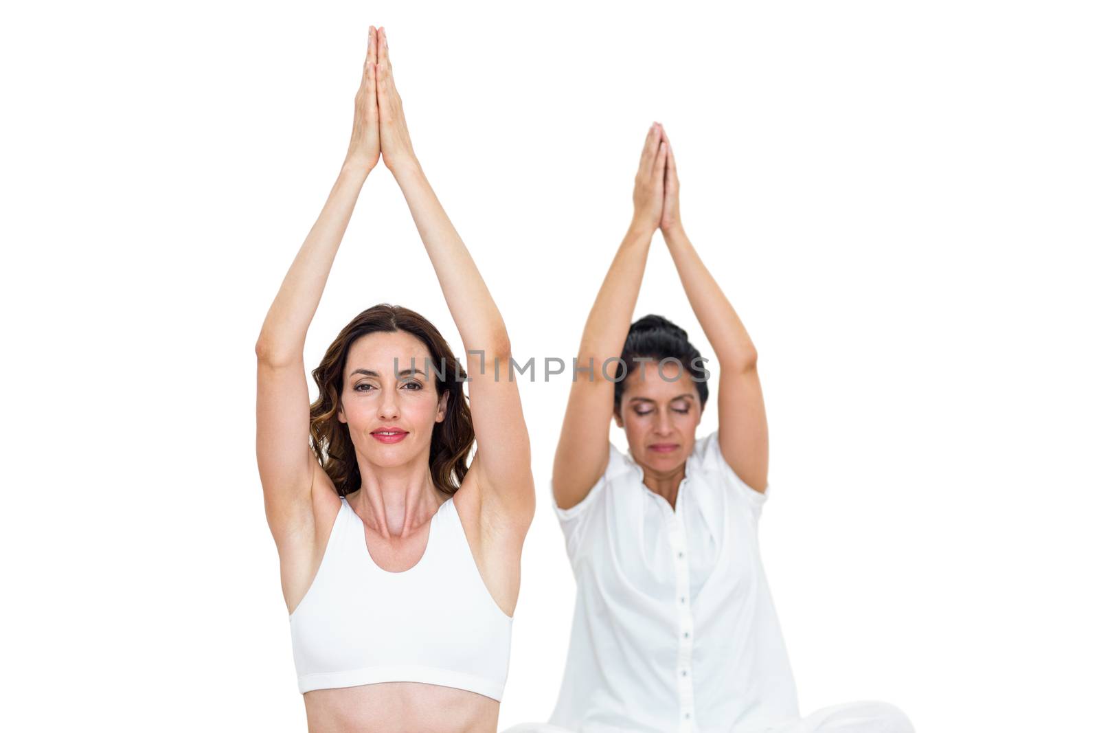 Relaxed women raising arms on white background