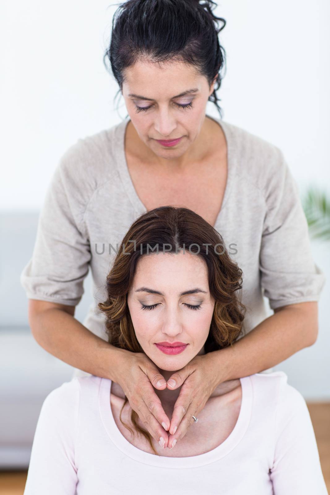 Woman getting reiki therapy on white background