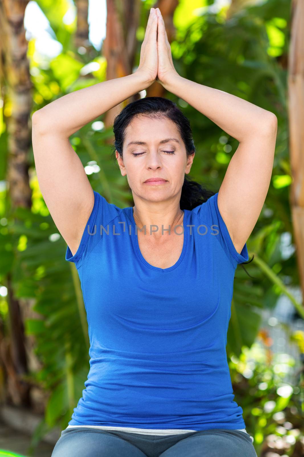 Relaxed woman doing yoga on a sunny day