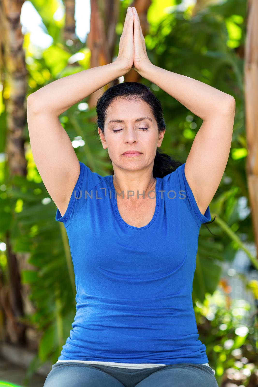 Relaxed woman doing yoga on a sunny day