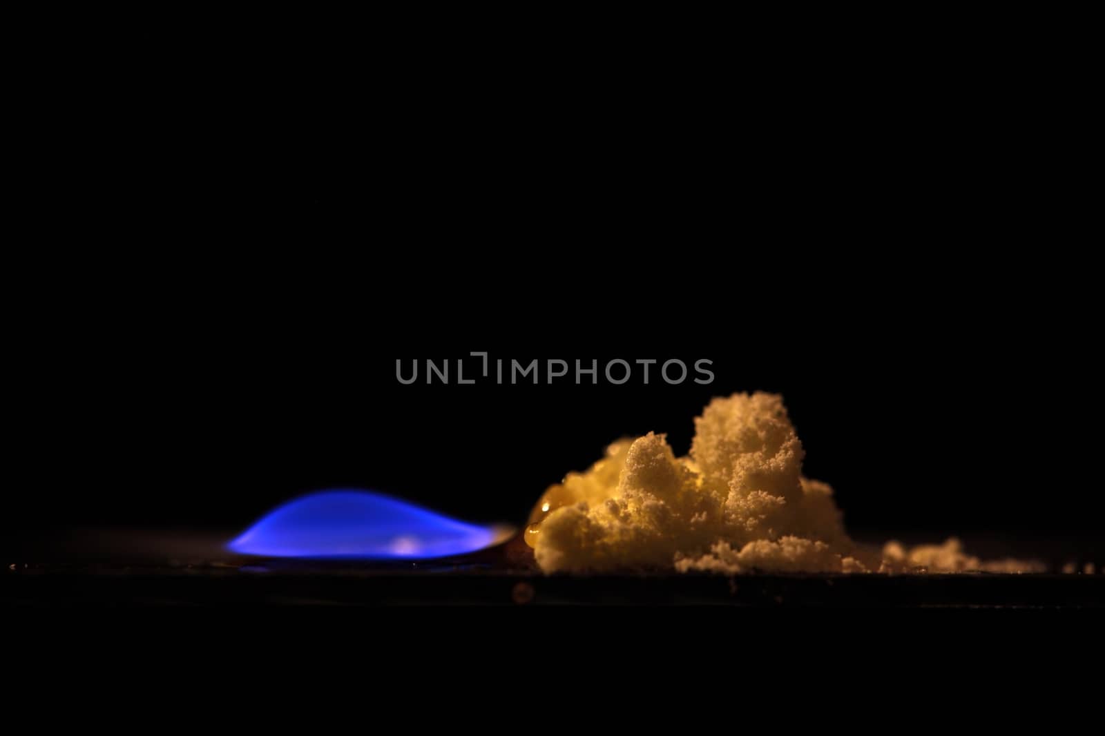 A macro photography of burning sulfur powder.