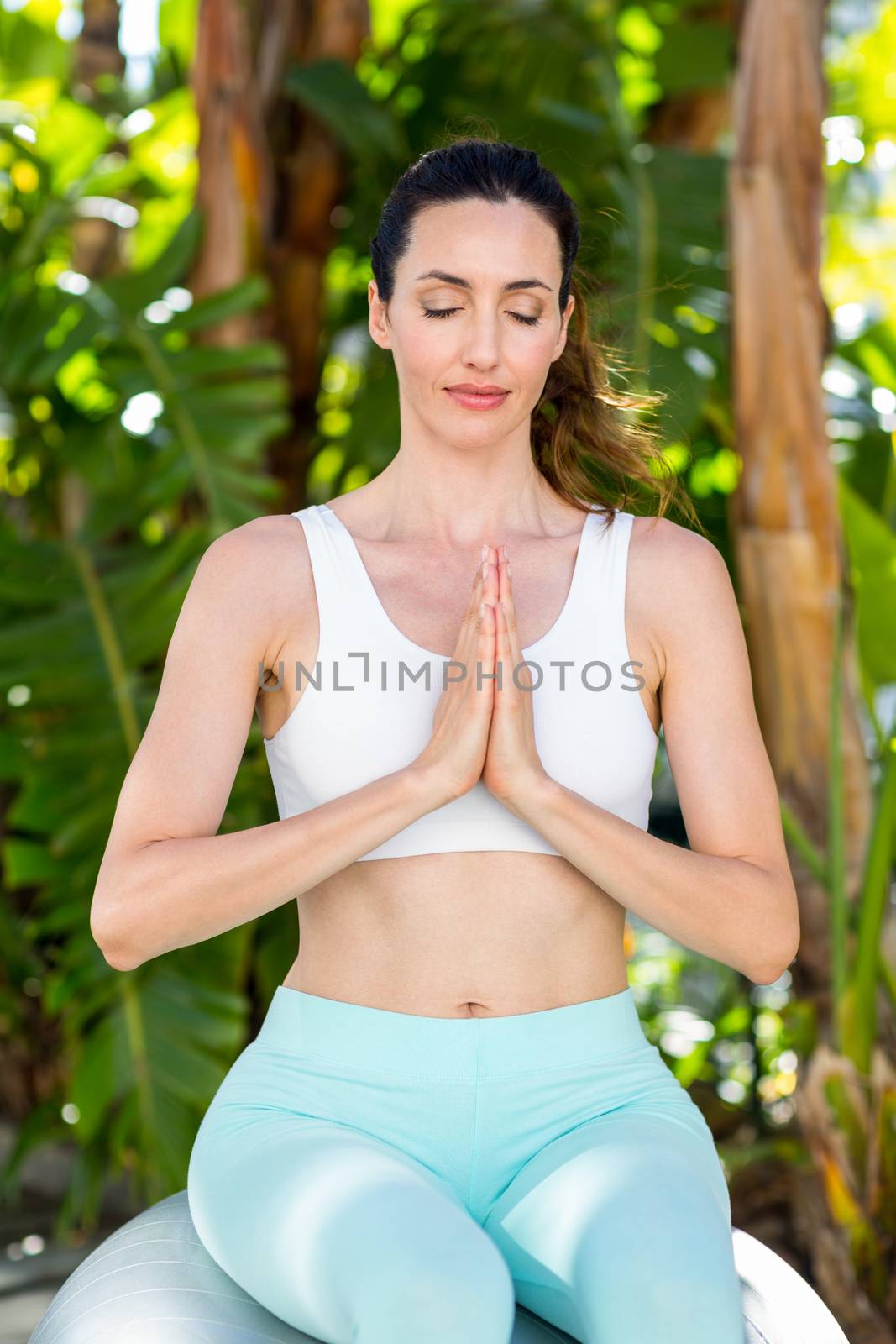 Smiling woman doing yoga by Wavebreakmedia