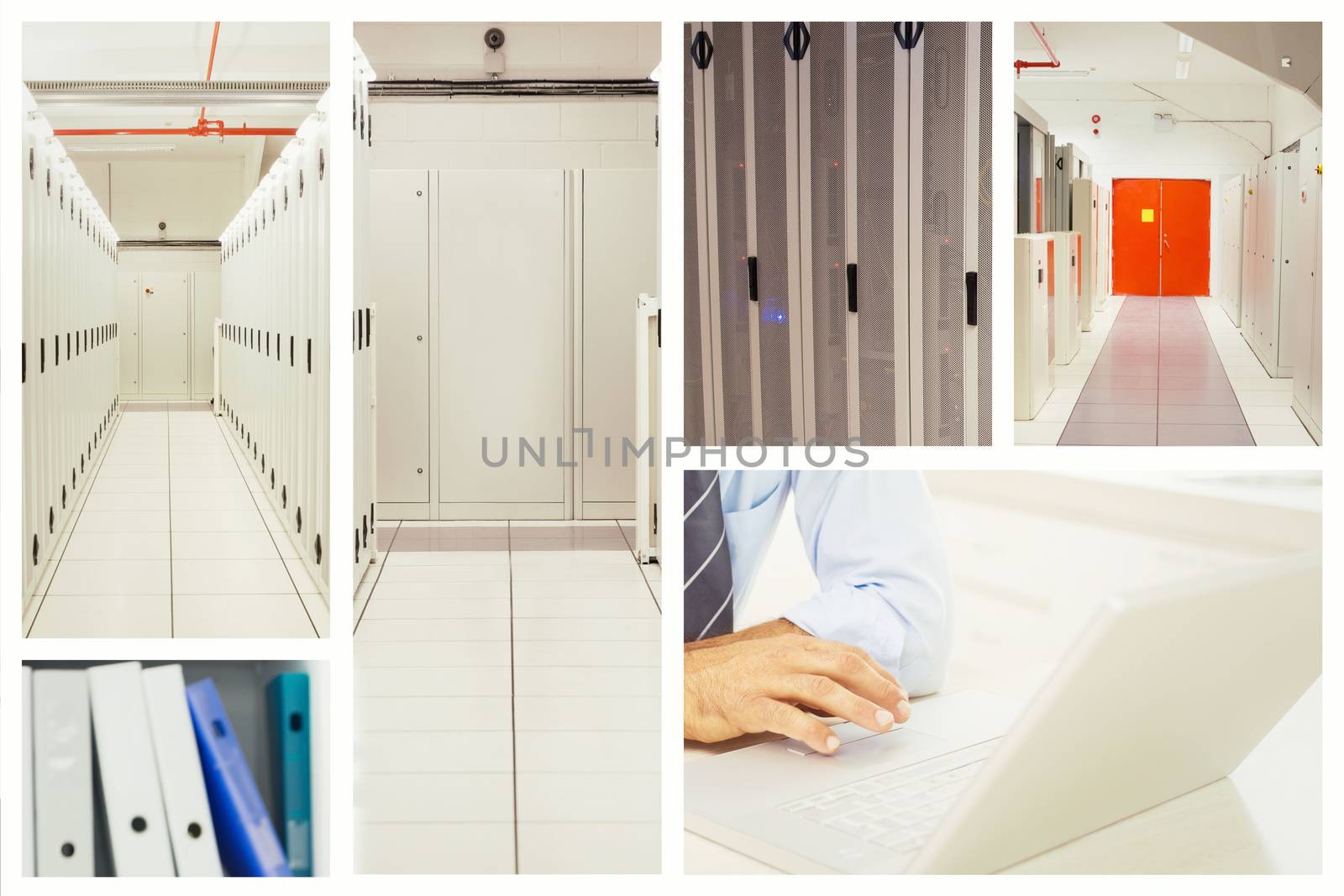 Handsome man working at his desk on laptop smiling at camera against data center